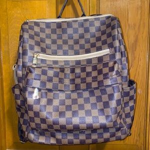 Brown checkered backpack with shoulder strap